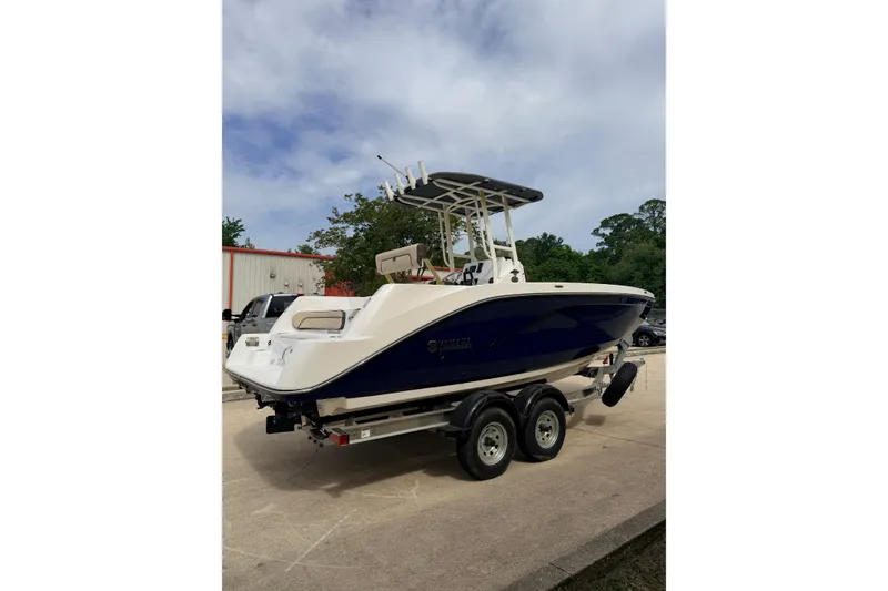 Slide: The Image of 2026 Yamaha Boats 222 FSH Sport on trailer, parked outdoors. - 4