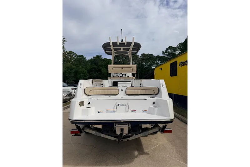 Slide: The Image of 2026 Yamaha Boats 222 FSH Sport, rear view, parked outdoors. - 5