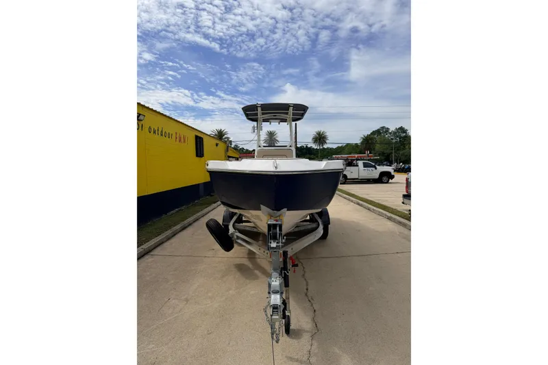 Slide: The Image of 2026 Yamaha Boats 222 FSH Sport on trailer, parked outdoors under a partly cloudy sky. - 6