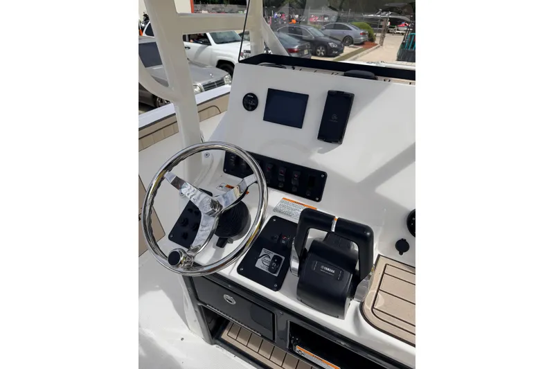 Slide: The Image of 2026 Yamaha Boats 222 FSH Sport dashboard with steering wheel and controls. - 8