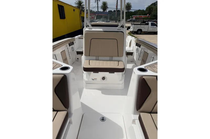 Slide: The Image of 2026 Yamaha Boats 222 FSH Sport interior with beige seating and cup holders. - 9