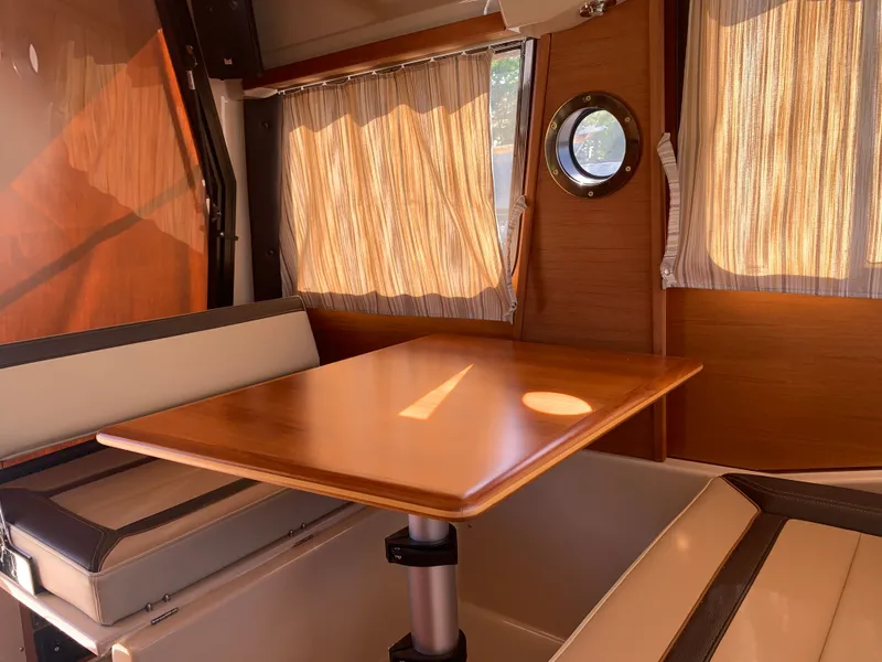 Slide: The Image of Interior of 2018 Ranger Tugs R-23 yacht with wooden table and seating area. - 10