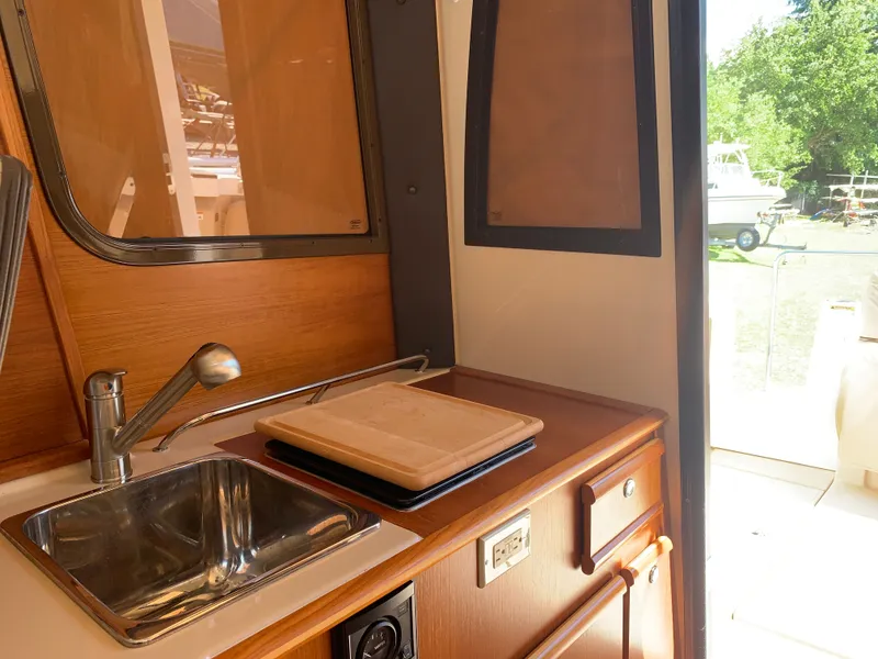 Slide: The Image of Interior of 2018 Ranger Tugs R-23 yacht with sink and cutting board. - 13