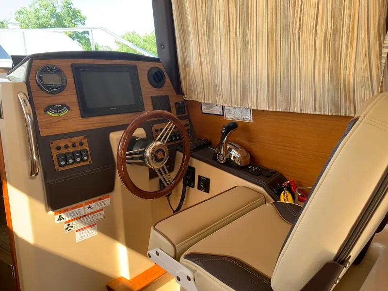 Slide: The Image of Interior of 2018 Ranger Tugs R-23 boat with steering console. - 16