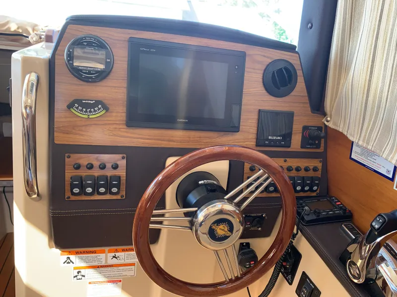 Slide: The Image of Helm console of a 2018 Ranger Tugs R-23 boat. - 18