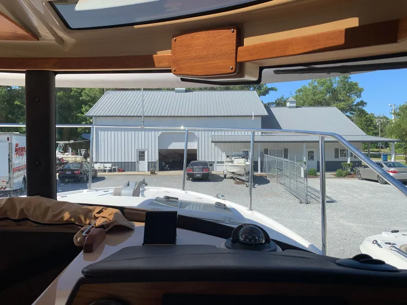 Slide: The Image of Interior view of a Ranger Tugs R-23 boat, overlooking a building. - 19
