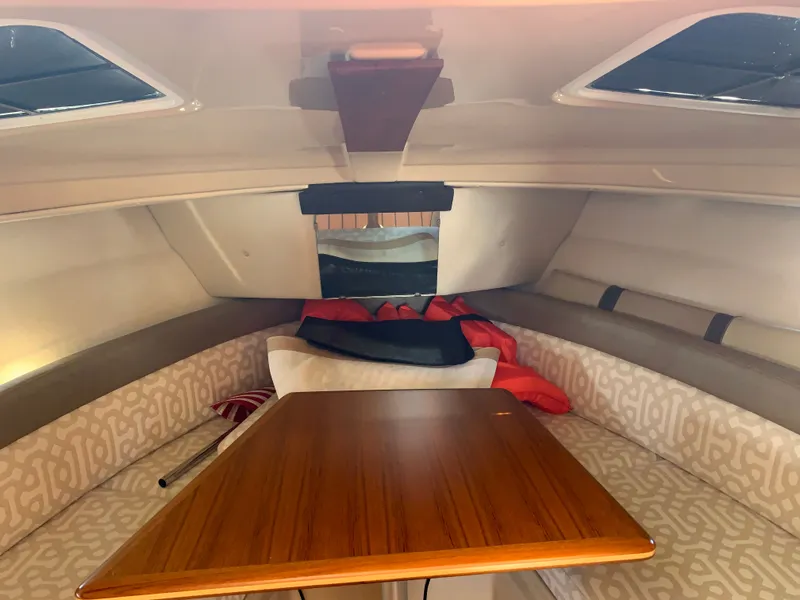 Slide: The Image of Interior of a 2018 Ranger Tugs R-23 with wooden table and seating area. - 30