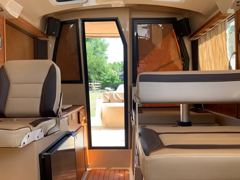 Slide: The Image of Interior of a 2018 Ranger Tugs R-23 with beige seating. - 31