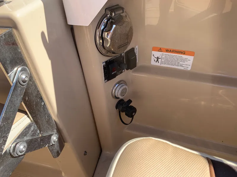 Slide: The Image of 2018 Ranger Tugs R-23 boat controls with warning label. - 36