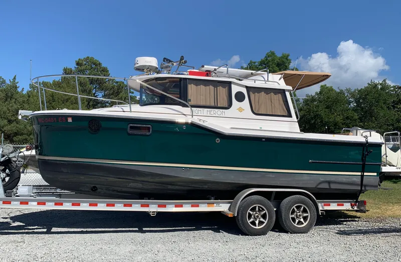 Slide: The Image of 2018 Ranger Tugs R-23 boat on trailer, green and white. - 4