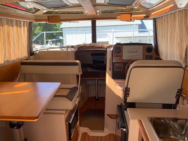 Slide: The Image of Interior of 2018 Ranger Tugs R-23 with helm and seating area. - 9
