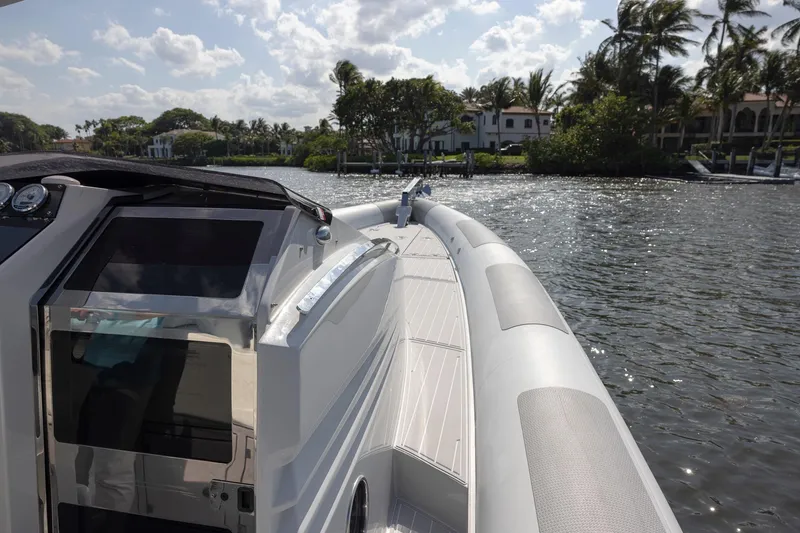 Slide: The Image of 2013 Zeta Elle 34 Custom boat on a sunny day by the water. - 11