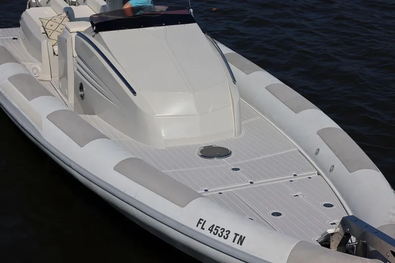 Slide: The Image of 2013 Zeta Elle 34 Custom boat on water, featuring sleek design and comfortable seating. - 2