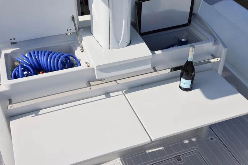 Slide: The Image of 2013 Zeta Elle 34 Custom boat deck with storage, hose, and champagne bottle. - 28