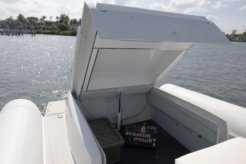 Slide: The Image of Open storage compartment on 2013 Zeta Elle 34 Custom boat by the water. - 29