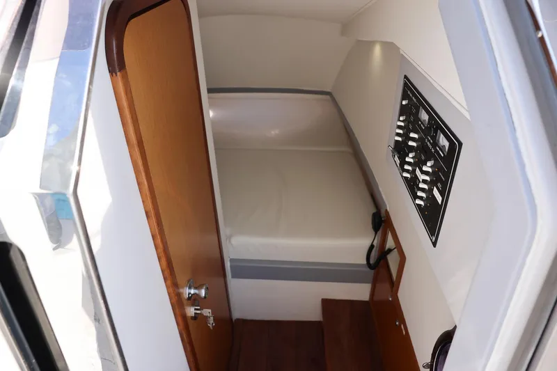 Slide: The Image of Interior cabin of 2013 Zeta Elle 34 Custom boat with control panel and wooden door. - 32