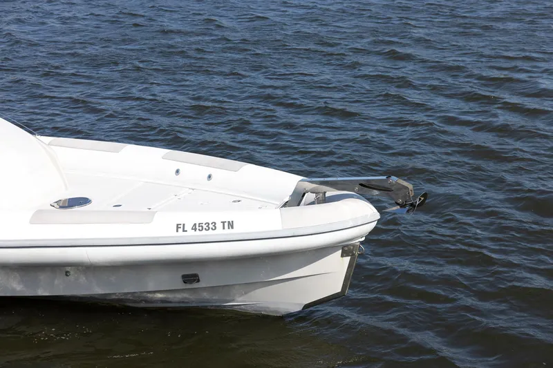 Slide: The Image of White 2013 Zeta Elle 34 Custom boat on water, displaying registration FL 4533 TN. - 4