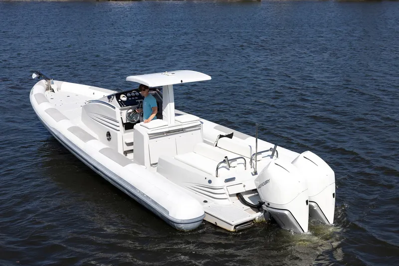 Slide: The Image of 2013 Zeta Elle 34 Custom boat on water with dual outboard engines. - 6