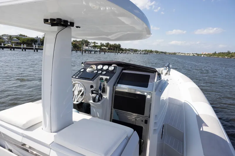 Slide: The Image of 2013 Zeta Elle 34 Custom boat interior with steering console on a sunny day. - 9