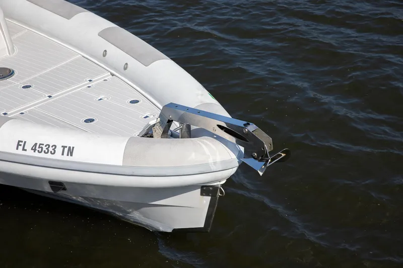 Slide: The Image of Bow of 2013 Zeta Elle 34 Custom boat on water, featuring anchor mechanism. - 13