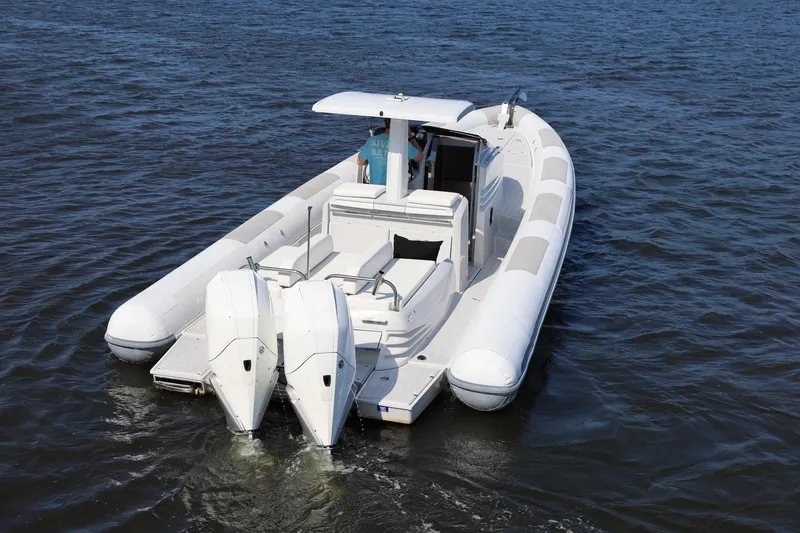 Slide: The Image of 2013 Zeta Elle 34 Custom boat with dual engines on open water. - 15