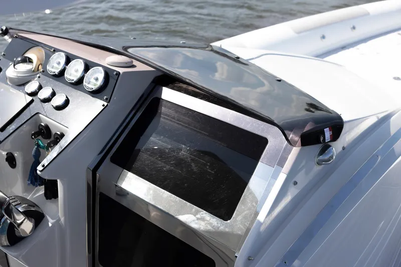 Slide: The Image of Control panel of a 2013 Zeta Elle 34 Custom boat with gauges and steering wheel. - 17