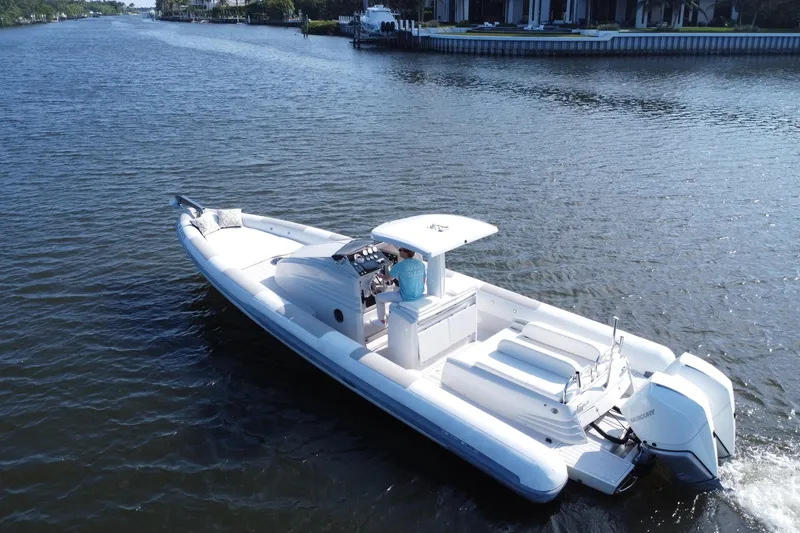 Slide: The Image of 2013 Zeta Elle 34 Custom boat cruising on a serene river. - 2