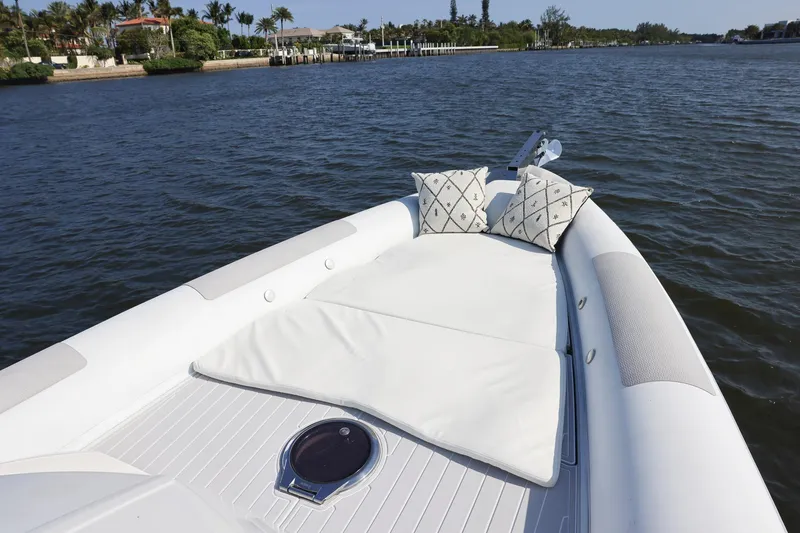 Slide: The Image of Luxurious 2013 Zeta Elle 34 Custom boat with cushioned deck on serene water. - 22