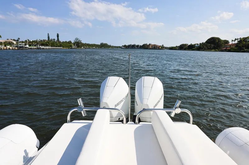 Slide: The Image of Rear view of 2013 Zeta Elle 34 Custom boat with twin Mercury engines on a sunny day. - 28