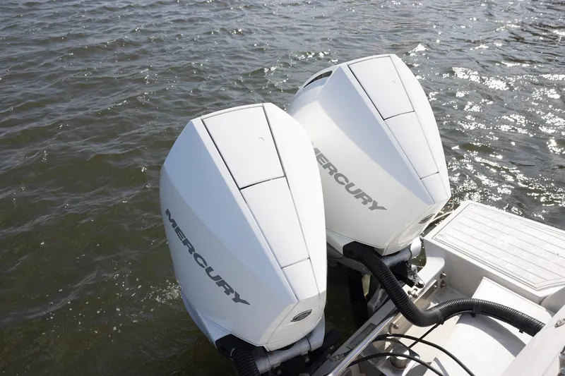Slide: The Image of Twin Mercury outboard engines on a 2013 Zeta Elle 34 Custom boat in water. - 29