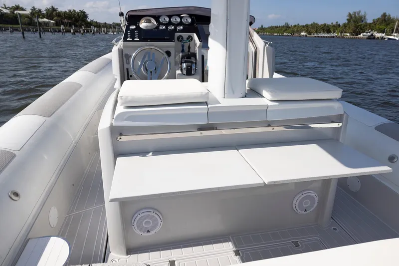 Slide: The Image of 2013 Zeta Elle 34 Custom boat interior with seating and control panel on water. - 33