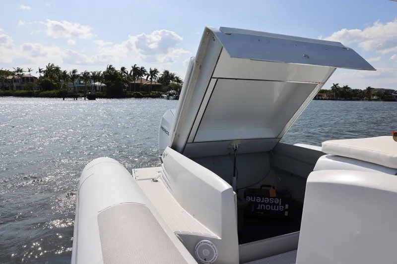 Slide: The Image of Zeta Elle 34 Custom boat, open storage compartment, sunny waterfront view, 2013 model. - 37