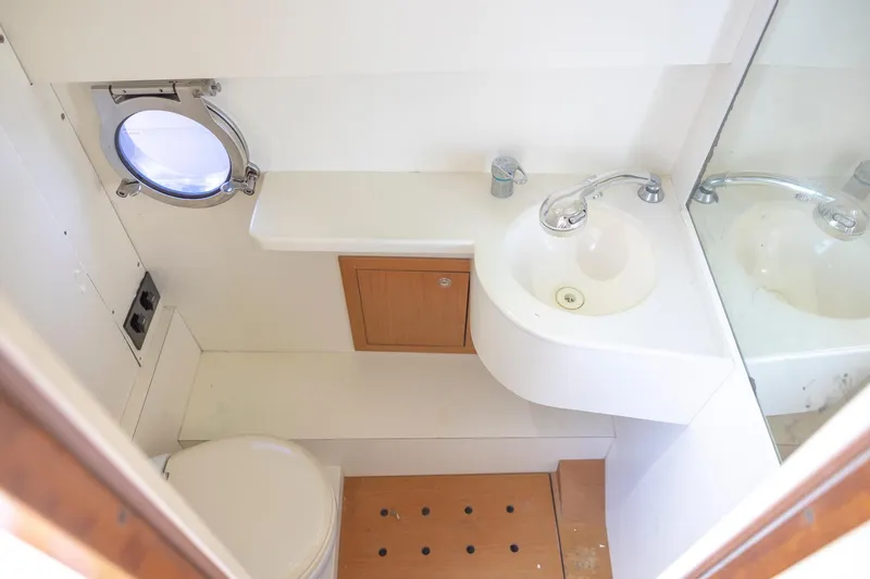Slide: The Image of Compact boat bathroom with sink, toilet, and porthole in 2013 Zeta Elle 34 Custom. - 41