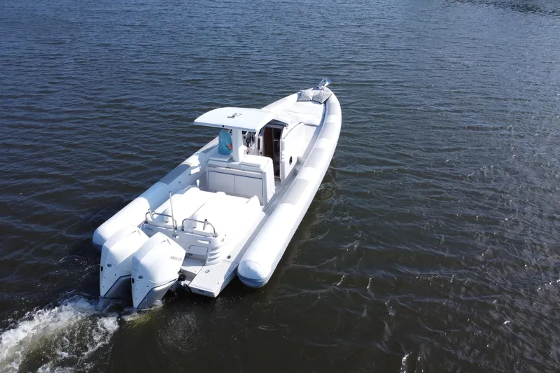 Slide: The Image of 2013 Zeta Elle 34 Custom boat cruising on open water. - 8
