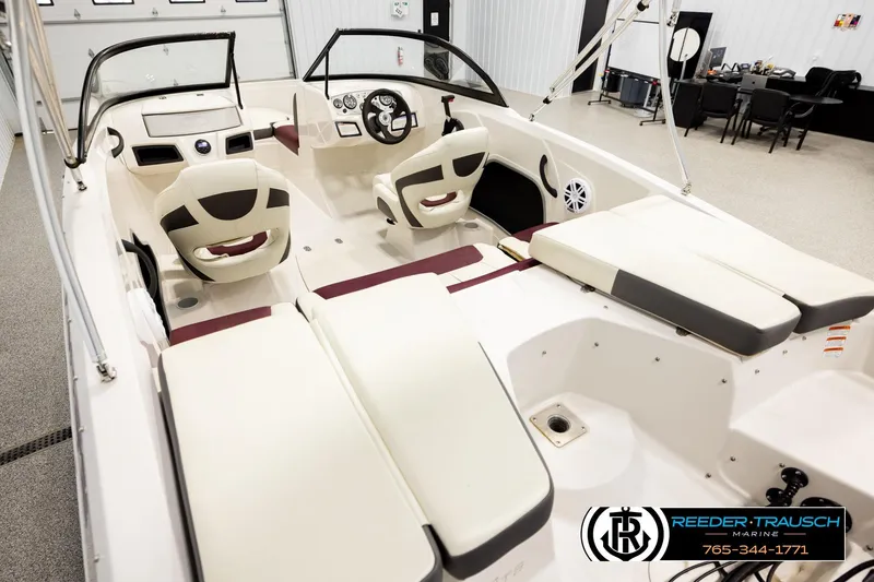 Slide: The Image of 2016 Tahoe 450 TS boat interior with seating and steering wheel in showroom. - 11