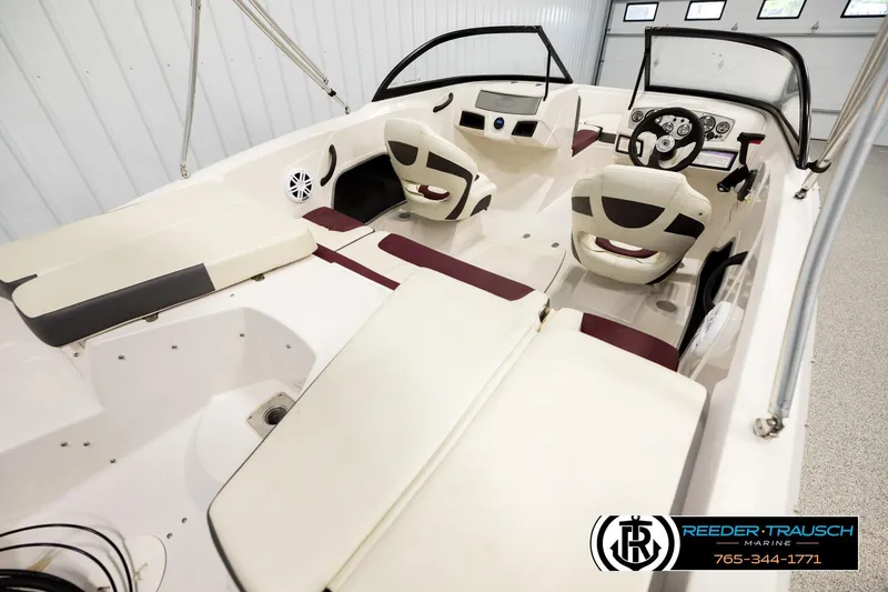 Slide: The Image of 2016 Tahoe 450 TS boat interior with seating and steering wheel in showroom. - 12