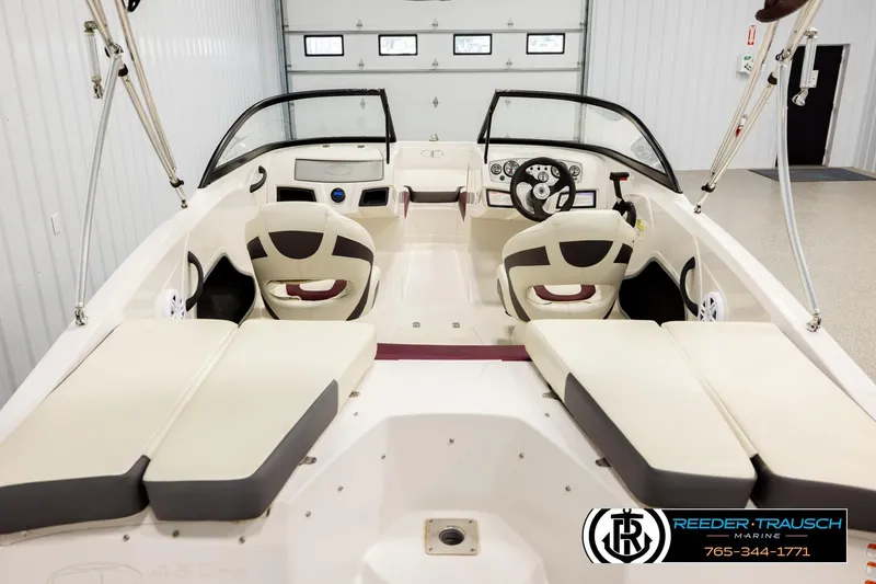 Slide: The Image of Interior view of a 2016 Tahoe 450 TS boat, featuring seating and steering console. - 13