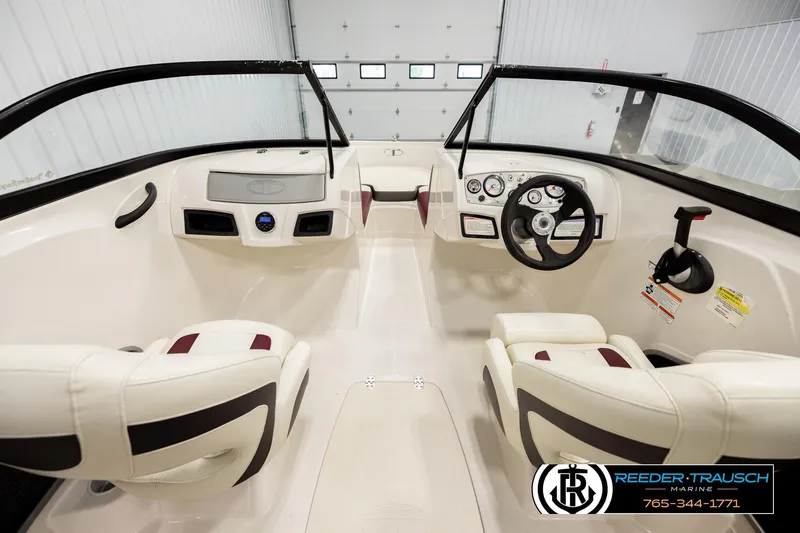Slide: The Image of 2016 Tahoe 450 TS boat interior with steering wheel and seating in a showroom. - 14