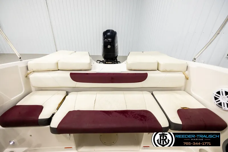 Slide: The Image of 2016 Tahoe 450 TS boat interior with cushioned seating and motor, Reeder-Trausch Marine branding. - 18