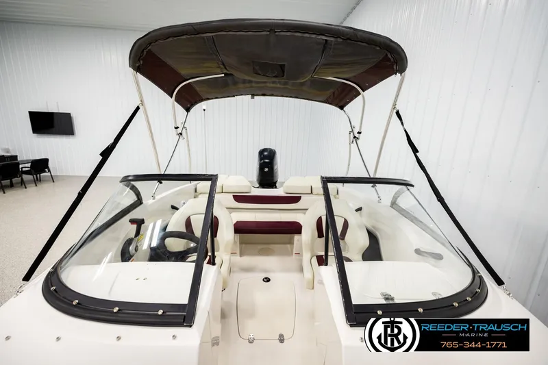 Slide: The Image of 2016 Tahoe 450 TS boat with canopy in indoor showroom. - 24