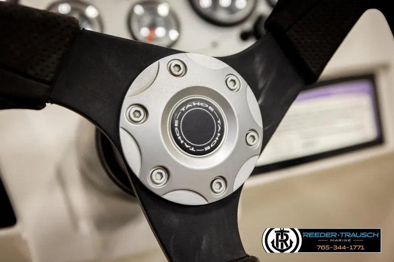 Slide: The Image of Steering wheel of a 2016 Tahoe 450 TS boat with logo detail. - 28