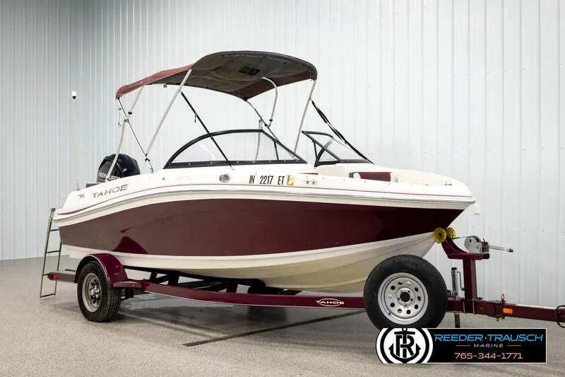 Slide: The Image of 2016 Tahoe 450 TS boat on trailer in indoor showroom setting. - 3