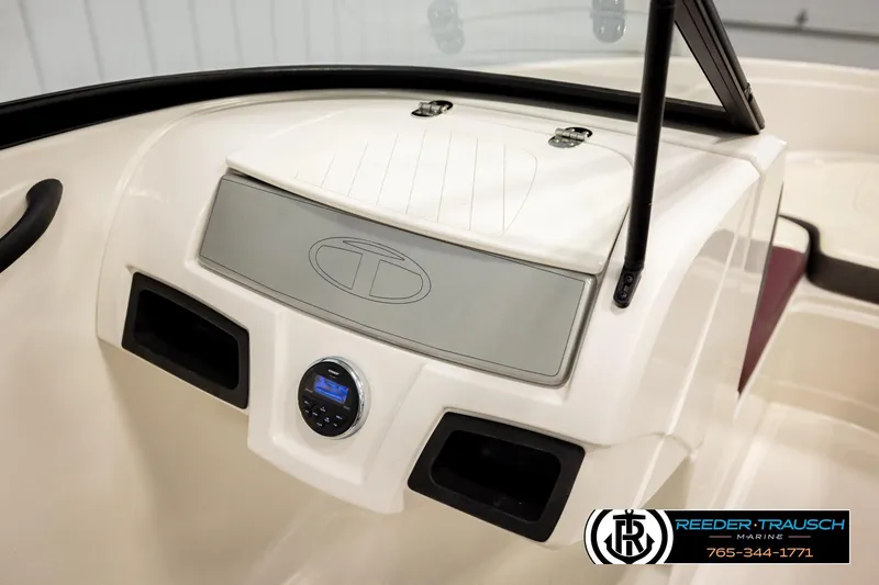 Slide: The Image of Dashboard of a 2016 Tahoe 450 TS boat with stereo system and logo. - 31