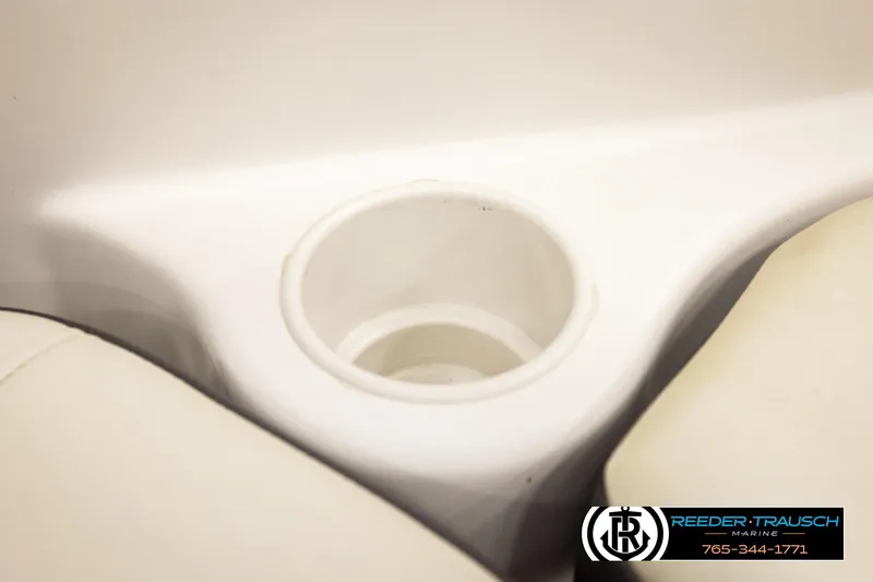 Slide: The Image of Cup holder in a 2016 Tahoe 450 TS boat interior, featuring beige seating. - 34
