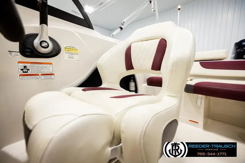 Slide: The Image of 2016 Tahoe 450 TS boat interior with white and maroon seating, steering wheel visible. - 35