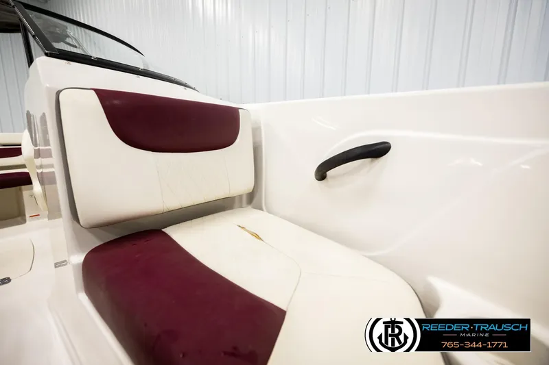 Slide: The Image of Interior seating of a 2016 Tahoe 450 TS boat with maroon and white upholstery. - 36
