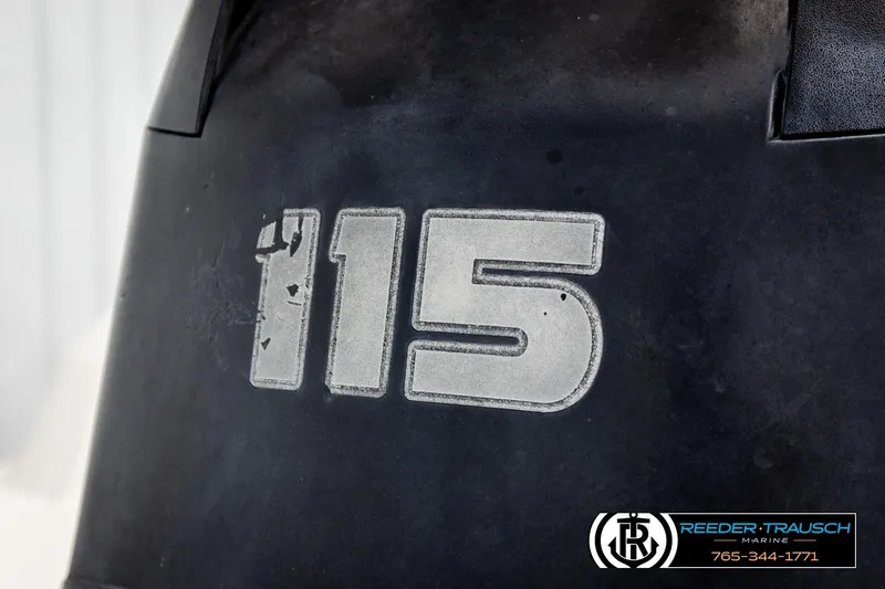 Slide: The Image of Close-up of a Tahoe 450 TS 2016 boat engine with "115" marking. - 39