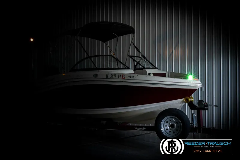 Slide: The Image of 2016 Tahoe 450 TS boat in dimly lit garage with trailer. - 4