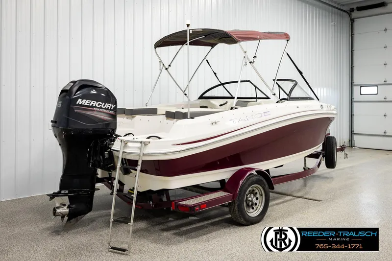 Slide: The Image of 2016 Tahoe 450 TS boat with Mercury outboard motor in a garage setting. - 6