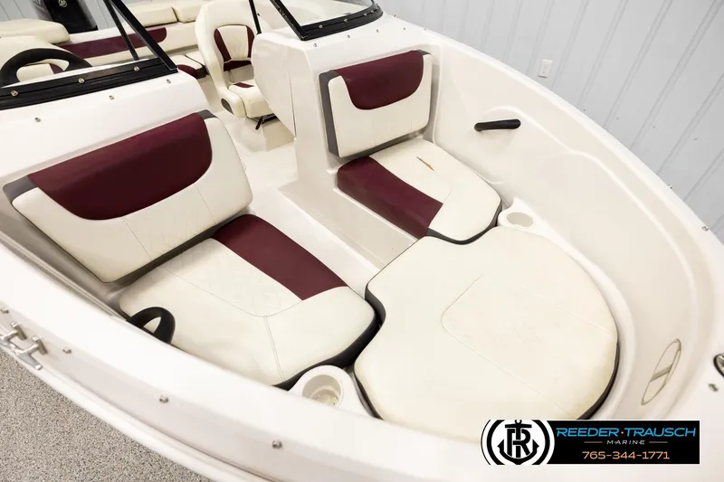 Slide: The Image of Interior of a 2016 Tahoe 450 TS boat with maroon and white seating. - 9